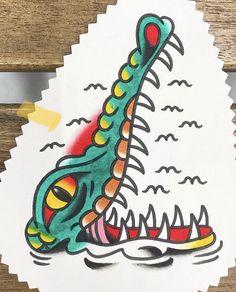 a sticker with an image of a green dragon's head and teeth on it