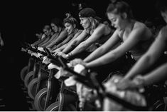 a group of people riding bikes in a row