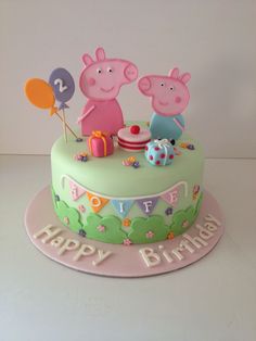 a peppa pig birthday cake with balloons and decorations