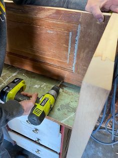 a person using a power drill to attach a piece of wood