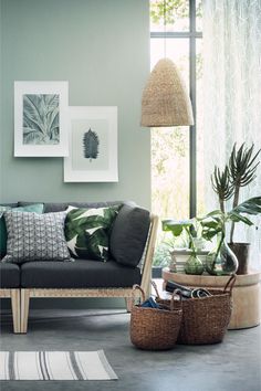 a living room filled with furniture and plants