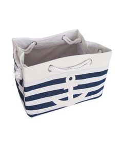 a blue and white striped storage basket with an anchor on the front, roped handles