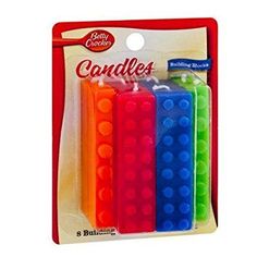 four assorted colored candles in plastic packaging