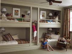 there are two kids playing on the bunk beds in this room and one is climbing up