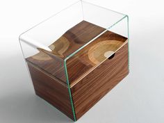 a glass box with wood inside on a white surface