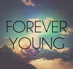 the words forever young are in front of a sky with clouds and sun shining through it