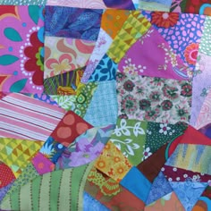 a colorful patchwork quilt with lots of different colors and patterns on it's edges