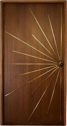 a wooden door with gold needles on it