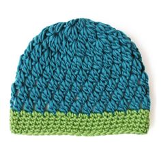 a blue and green knitted hat on a white background