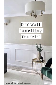 a living room with white paneling and a chandelier hanging from the ceiling