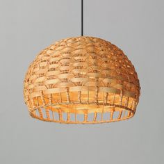 a light that is hanging from a ceiling with wicker shades on the lightshade