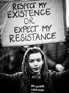 a person holding up a sign that says respect my existence or expect my resistance