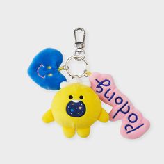 a stuffed animal keychain with a name tag attached to it's side