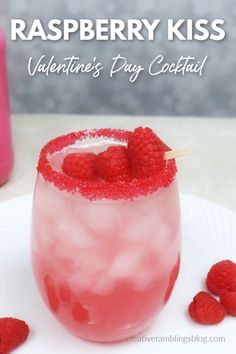 raspberry kiss valentine's party cocktail with strawberries on the rim and garnish