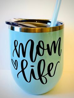 a blue cup with the words mom and life painted on it