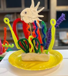 a yellow plate topped with cake covered in icing and sea animals on top of it