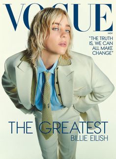 a woman in a suit and tie on the cover of a magazine, with her hands behind her back