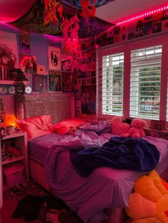 a bed room with a neatly made bed and pink lighting