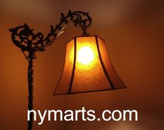 a lamp that is sitting on top of a table next to a light bulb with the word nymarts com written below it