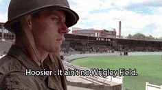 a man wearing a hat sitting in front of a baseball field with the words hosier i want to wrigley field