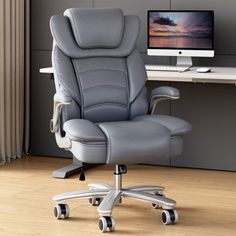 an office chair sitting in front of a desk with a computer monitor and keyboard on it