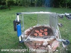 a bbq grill that is sitting in the grass with some food cooking on it