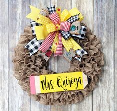 a burlock wreath with the words mrs quiiega on it and a ribbon