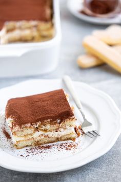 a piece of cake sitting on top of a white plate next to a knife and fork