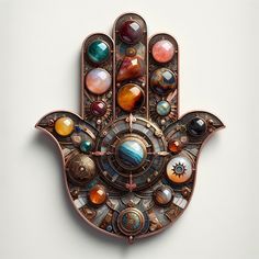 a metal hamsa with many different colored stones on it's face and hands