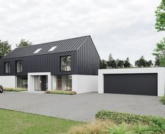 a black and white house with two cars parked in the driveway