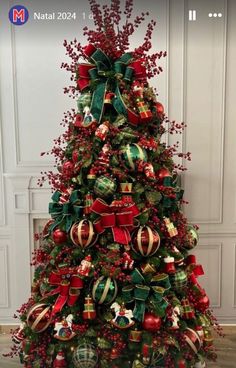 a christmas tree decorated with red, green and gold ornaments