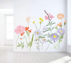 an empty room with flowers painted on the wall