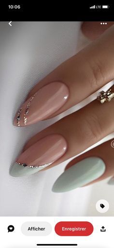 a woman's hand with long, stiled nails and gold ring on it