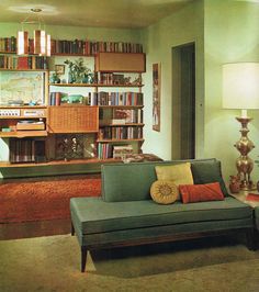 a living room filled with furniture and lots of books