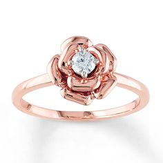 a rose shaped ring with a white diamond in the center