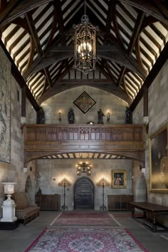 the inside of a large building with an ornate ceiling and chandelier hanging from the rafters