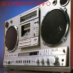 an old fashioned boombox with speakers and radio on it's side, in front of a purple background