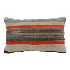 a multicolored striped pillow on a white background