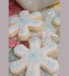 some frosted snowflake cookies are on the table