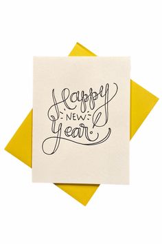 a card with the words happy new year written in cursive writing on it