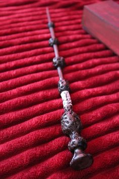 a long metal object on top of a red blanket