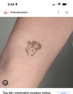 a small monkey tattoo on the arm