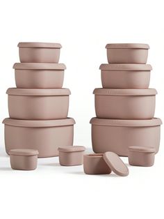 a stack of pink pots with lids on each one and several smaller ones in the middle