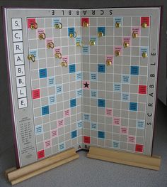 a scrabble board game is opened to show the pieces and numbers on it