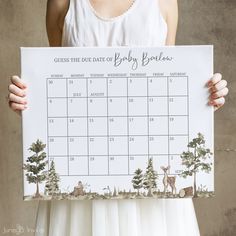 a person holding up a calendar with animals on it