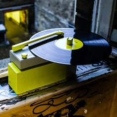 an old record player sitting on top of a window sill