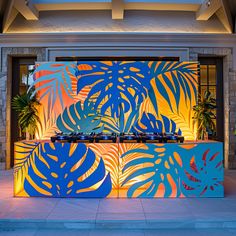 a brightly lit counter with blue and yellow leaves on it in front of a building