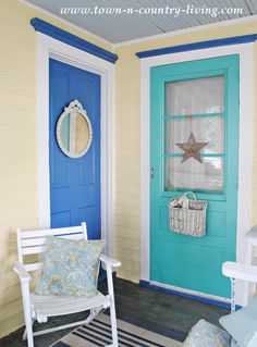 the front door is painted bright blue and has a white rocking chair in front of it