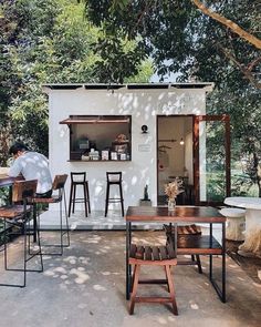 an outdoor dining area with tables and stools