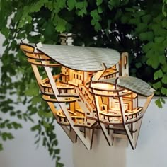 a house made out of wooden planks with lights in the roof and trees behind it